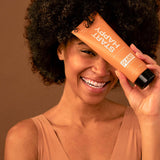 An orange squeeze bottle body wash that says “Start Happy”, “Citrus and Frakincense” and by “Plant apothecary” a plant based body wash