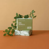 A green box of bar soap that says “Be well”, “Cypress and Eucalyptus” by Plant apothecar