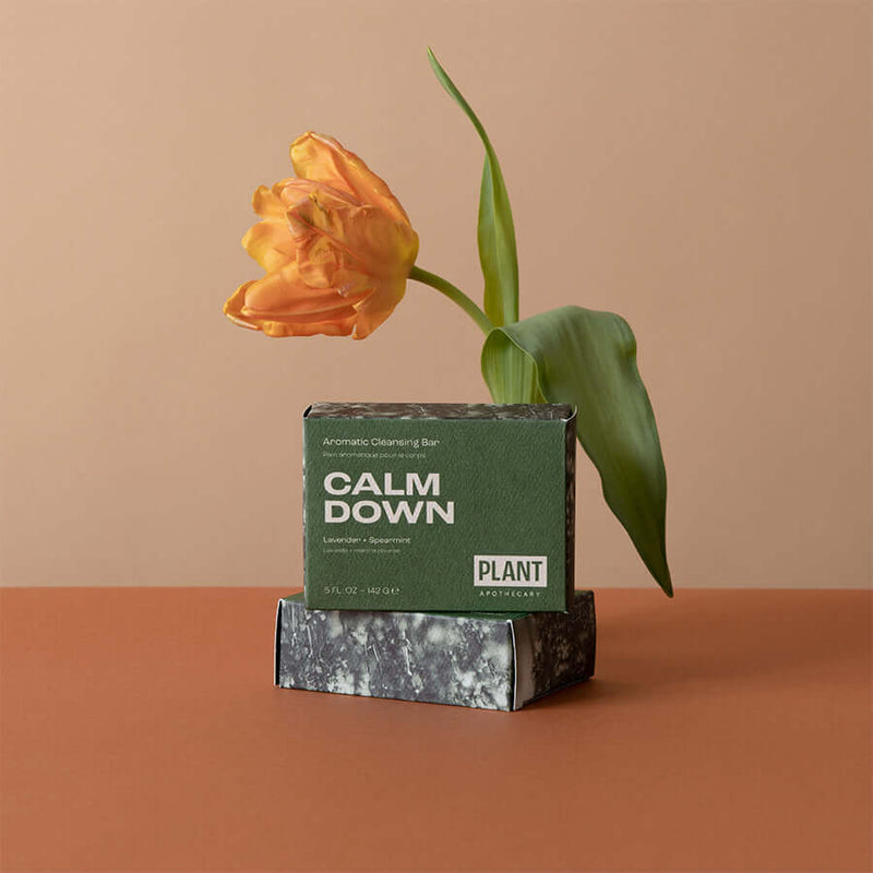 A green box of bar soap that says “calm down”, “Lavender and spearmint” by Plant apothecary