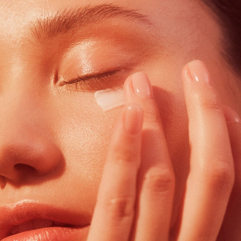 close up attractive pretty young woman applying plant apothecary firm believer under eye cream